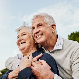 Smiling couple embracing outdoors
