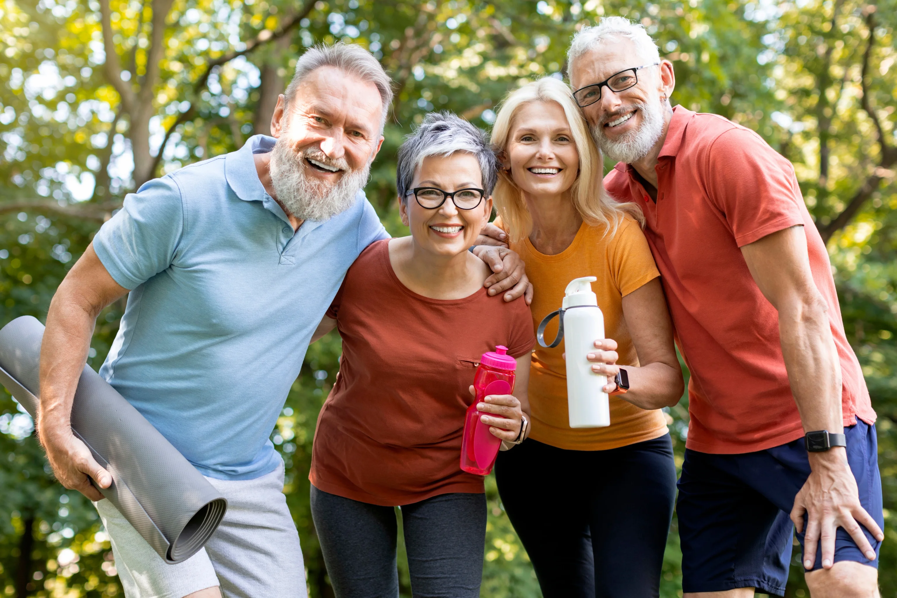 Group of smiling friends embracing outdoors